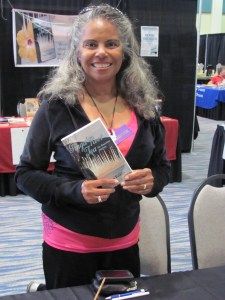 Naomi Pringle proudly displays a copy of her book, "Ginga Root Tea"